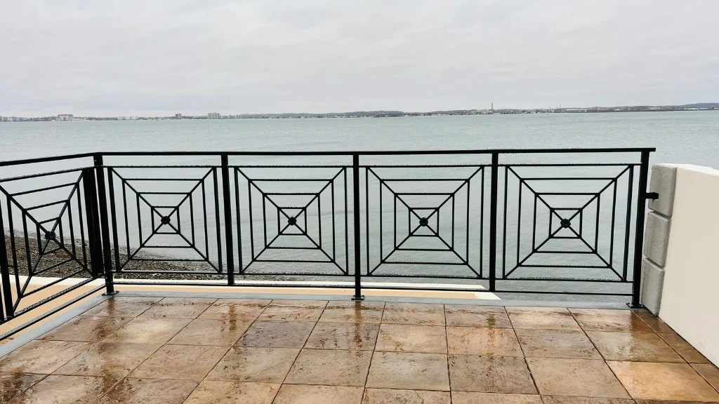 Decorative black metal railing overlooking the water