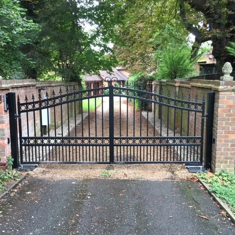 Custom black iron driveway gate installed at a residential property