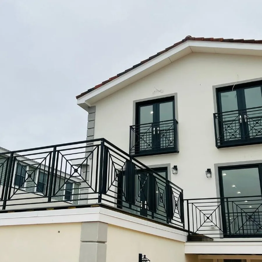 Black decorative balcony railings on a modern residential exterior