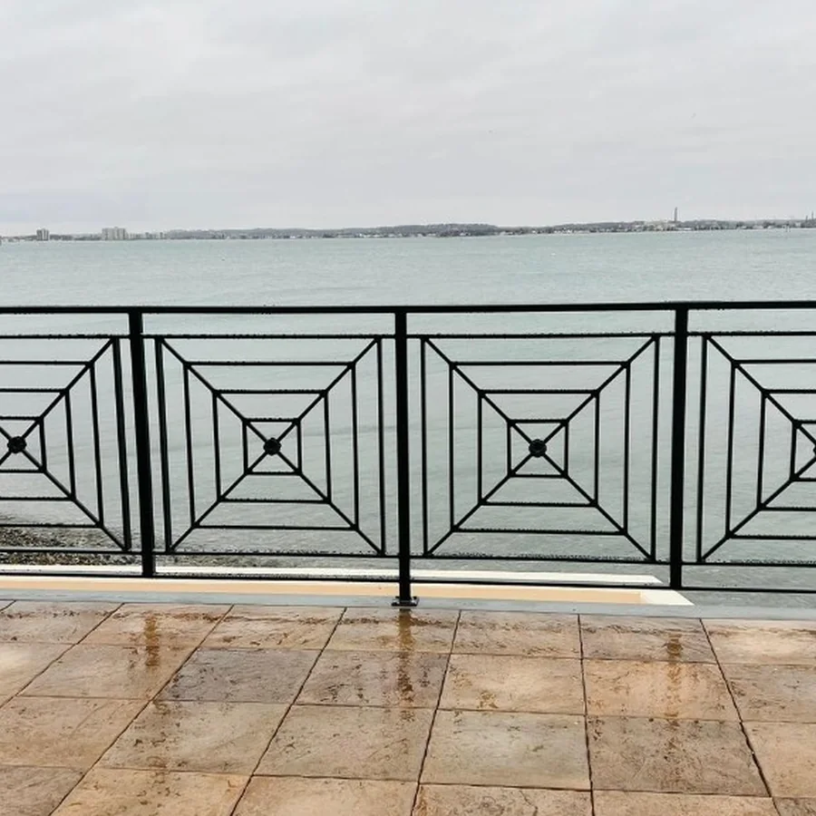 Decorative black metal railing overlooking the water
